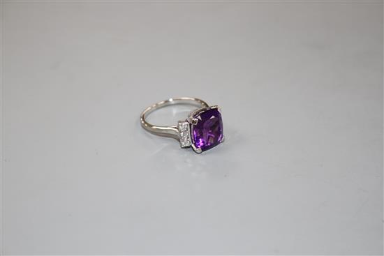 A white metal, amethyst and six stone diamond set dress ring, size R/S, gross weight 6.2 grams.